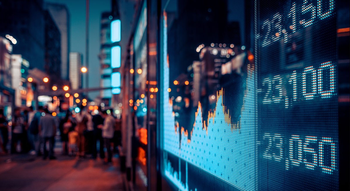 A large outdoor screen displaying stock market data, designed for vibrant visuals and resilience against urban noise.